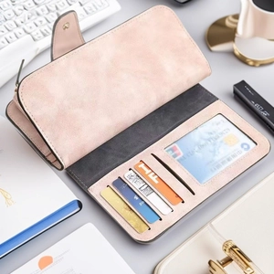 Macro shot of pink matte leather long wallet interior showing card slots and compartments