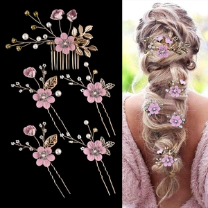 Detailed view of pink floral hair comb and pins set for bridal wedding hairstyles