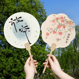Traditional Chinese hand fans with bamboo handles and calligraphy against nature backdrop