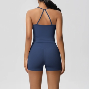 Close-up of the cross-back straps and stitching detail on the navy yoga sports top