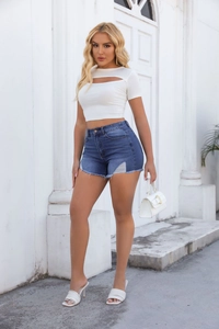 Detail of high-waist dark blue denim shorts with frayed hems and ripped texture accents