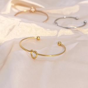 Minimalist knot open heart bracelets in gold and silver finish on silk fabric