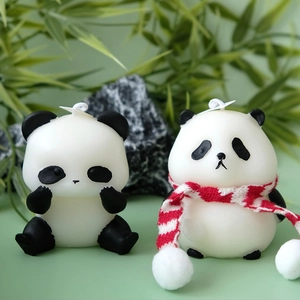 Panda scented candle set with striped scarf and bamboo leaves on green background