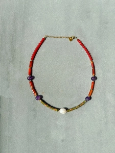 Detail view of handmade beaded necklace featuring freshwater pearl and colorful beads