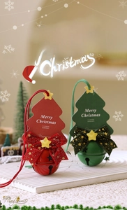 Detailed view of red and green Christmas bell ornaments with festive bows and card tags