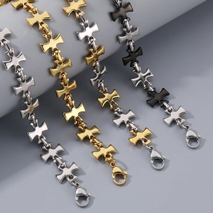 Detail of four stainless steel cross link bracelets in silver, gold, two-tone and black