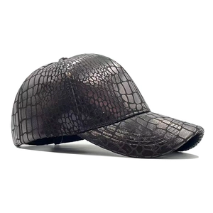Macro detail of the dark crocodile pattern texture on a premium PU leather baseball cap