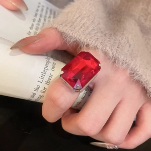 Macro detail of a vintage square red gemstone ring set in silver on a model hand