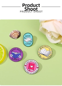 Detailed macro view of four colorful enamel pins featuring reading and book club designs