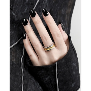 Minimalist S925 sterling silver ring with gold edges and irregular lava texture worn by model