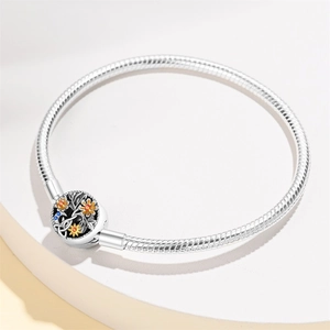 Detailed macro view of silver snake chain bracelet with crystal floral clasp