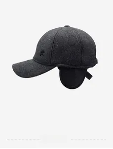 Close-up of charcoal grey wool baseball cap with side ear flaps and letter R logo