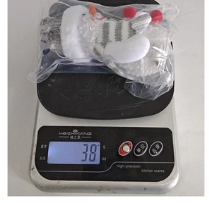 Glow snowman ornament weight measurement at 38g on electronic scale in factory