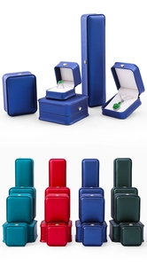 Various luxury crown jewelry boxes in blue, red, lake blue, and dark green leather