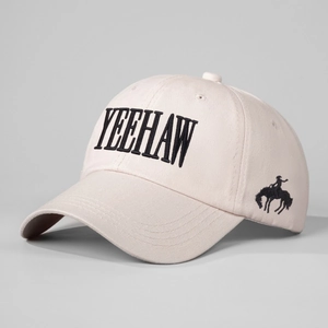 Beige canvas baseball cap with black Yeehaw embroidery and cowboy silhouette logo