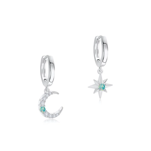 Detail of asymmetric S925 silver hoop earrings with opal moon and star pendants