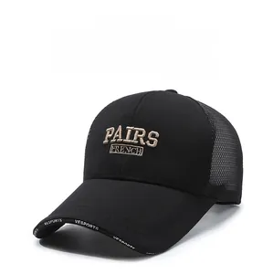 Close-up of black mesh baseball cap with beige 3D embroidery and breathable mesh panels