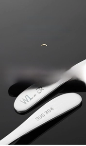 Macro shot of 304 stainless steel thick handle with brushed texture and engraved logo