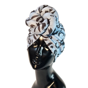 Detail of light blue faux suede headwrap with twisted knot design and abstract patterns