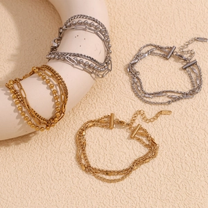 Detail of 18K gold and silver layered anklet chains with K18 stamp on art display