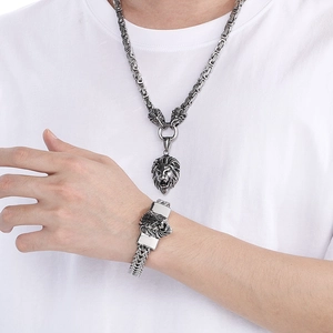 Detail of silver lion head necklace and bracelet set with dragon scales chain