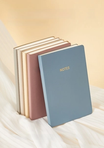 Close-up of A6 Morandi notebooks with soft matte PU covers and golden NOTES engraving