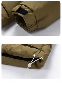 Detail view of adjustable velcro cuffs and drawstring hem on olive green winter jacket