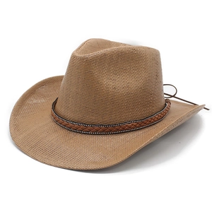 Detail of western straw hat featuring a brown braided leather band with metal rivet studs
