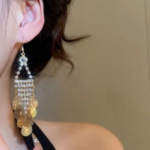 Elegant gold leaf tassel earrings with rhinestones on model in vintage style