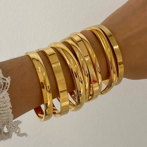 Polished 18K gold plated stainless steel bangles set for women displayed on wrist