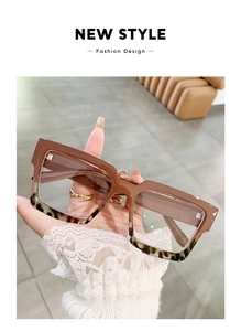 Detailed view of square brown and tortoiseshell eyeglass frames with blue light blocking