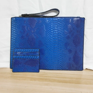 Detailed view of blue 3D python texture PU leather envelope clutch bag with matching card holder