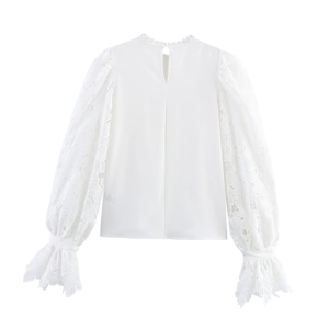 Elegant white long sleeve blouse with lace patchwork sleeves and back button detail