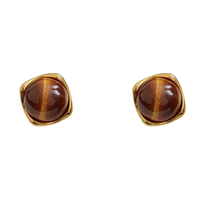 Vintage gold square resin earrings with tiger eye stone center on white background