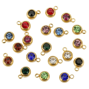 Flat lay of colorful birthstone pendants with gold plated stainless steel frames