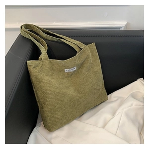 Detailed close-up of olive green corduroy tote bag showing fabric texture and fashion label