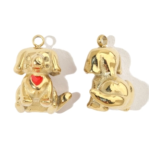 Detailed macro view of a golden stainless steel puppy pendant showing front and back faces