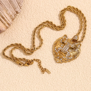 Detail of 18K gold plated tiger head pendant with twisted chain and 18K hallmark