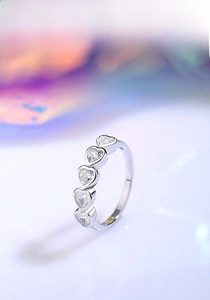 Detailed view of S925 silver ring featuring five heart-cut cubic zirconia stones