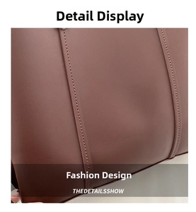 Close-up of high-quality brown leather texture and stitching on the large tote bag