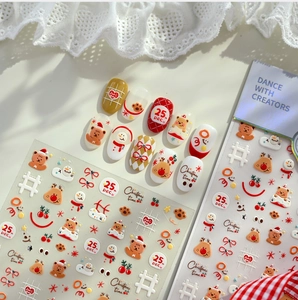 Close-up of 3D Christmas nail stickers with cute bears, reindeer, and snowman designs