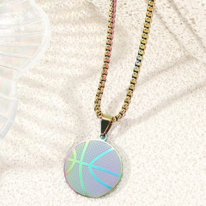 Close-up of rainbow iridescent basketball pendant with box chain on textured background