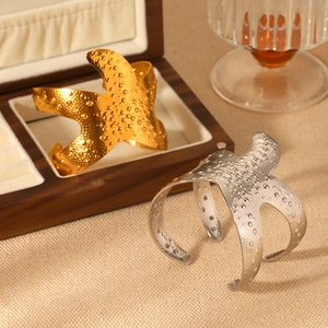 Starfish cuff bracelets in gold and silver finish with textured hammered surface detail