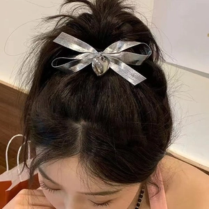 Silver bow hair tie with heart pendant accessory for high bun hairstyles for women