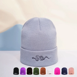 Detailed close-up of lavender knit beanie with black snake embroidery and color options