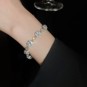 Macro detail of luxury heart-shaped zircon bracelet with sparkling silver finish