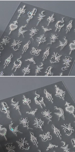 Detailed holographic nail stickers featuring white butterflies and moon motifs on a dark base