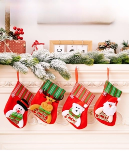 Set of 4 Christmas stockings with Santa, snowman, and reindeer hanging on a white fireplace