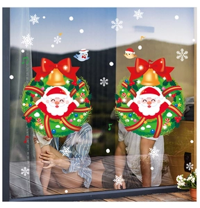 Detail view of Santa Claus wreath window stickers with snowflakes on glass pane