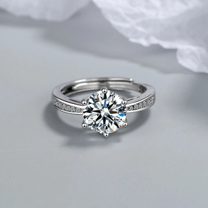 Classic six-prong round zircon silver ring with pavé side stones on grey background